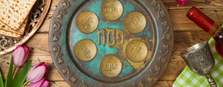 A Passover Seder plate with Hebrew inscriptions, featuring six indentations for symbolic foods.